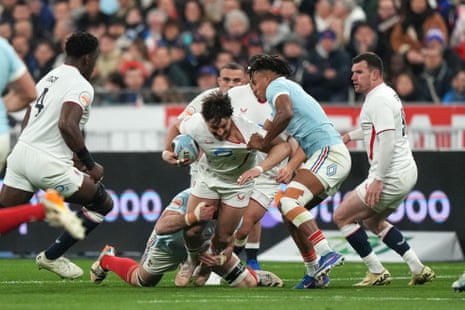 England's Cadan Murley, center, is tackled.