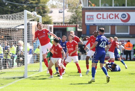 Callum Howe of York heads the ball against his own crossbar.