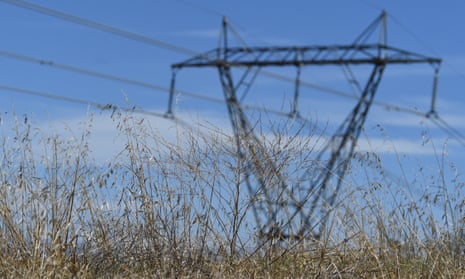 An electricity pylon in a field of grass