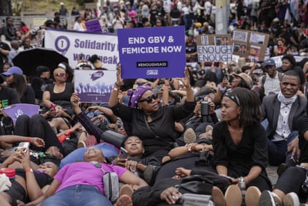 A protest against femicide, with marchers carrying banners with âÂÂEnough is Enoughâ and other slogans