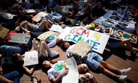 Young climate activists stage a "die-in" across from the White House on Earth Day in April  2022.