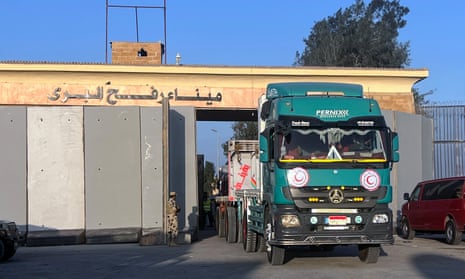 A truck carrying humanitarian aid bound for the Gaza Strip crosses the Rafah border crossing between Gaza and Egypt