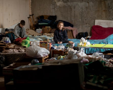 Alina and Artem, aged nine and from the city of Kharkiv in Ukraine, sit on a makeshift sofa in the underground car park which serves as a bomb shelter