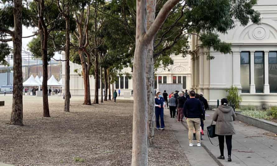 People queue outside the Royal Exhibition Building in Carlton on Wednesday morning.