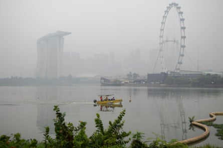 A boat passes Singapore’s Marina Bay Sands, shrouded in haze