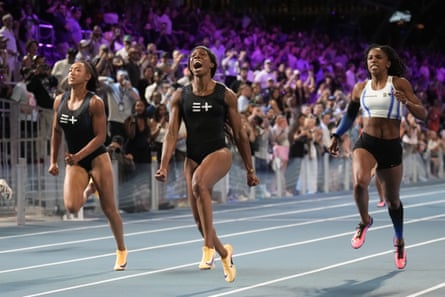 Tristan Evelyn, of Barbados, centre, celebrates as she wins the women’s 100m final while racing clean in Las Vegas.