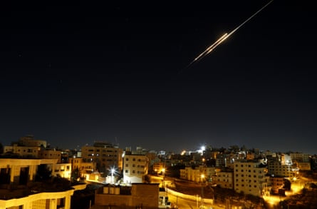 Missiles fired from Iran in retaliation for Israeli attacks are seen in the sky over the Hebron