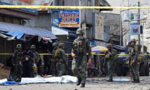 Philippine soldiers patrol the site of a deadly bomb blast in January in Sulu province, a stronghold of Islamist militants.