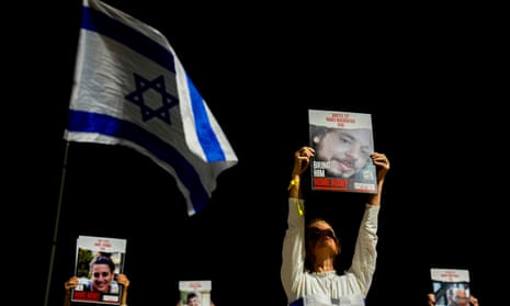 Families and supporters of Israeli hostages held by Hamas in Gaza hold their photos and shout slogans during a rally calling for their release, in Tel Aviv, Israel, on 30 December