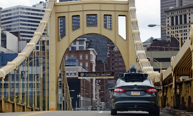 A self-driving Uber car drives navigates one of Pittsburgh’s many bridges.