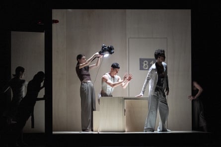 A camera operator films a dance on stage