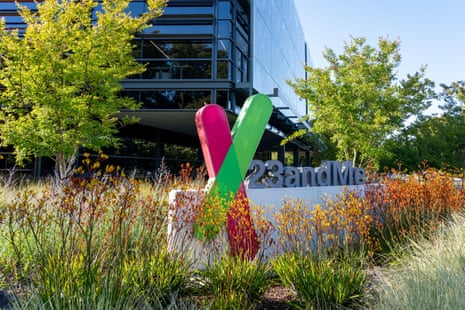 A colourful V-shaped sculpture stands beside the 23andMe headquarters sign amid foliage