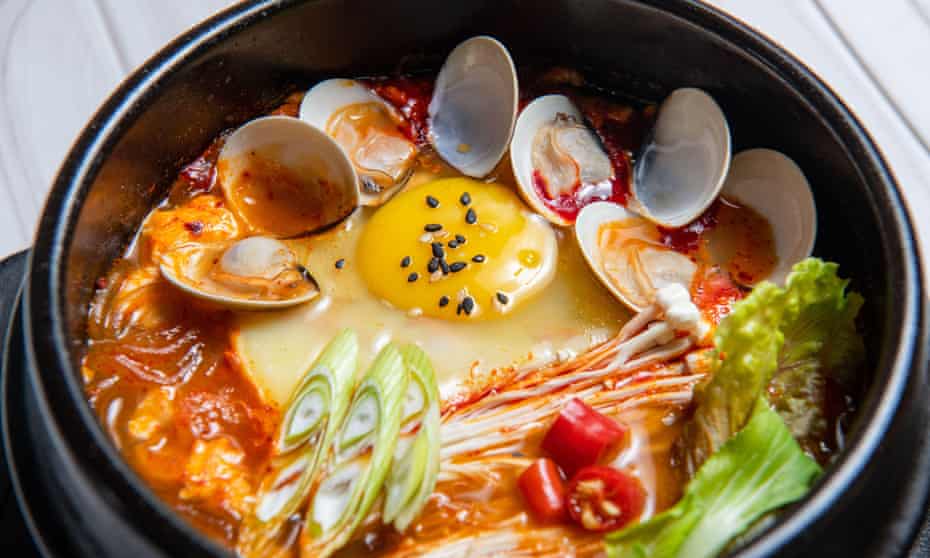 Kimchi stew can include scallions, onions, diced tofu, pork, tuna and a variety of seafood.