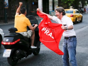 An anti-austerity ‘No’ voter waves a flag with the name of Prime Minister Tsipras as he celebrate the results of the first exit polls in Athens<br>An anti-austerity ‘No’ voter waves a flag with the name of Prime Minister Alexis Tsipras as he celebrate the results of the first exit polls in Athens, Greece July 5, 2015. Greeks voted by a large margin to reject the austerity terms of an aid package from international creditors, an official projection of the final result of Sunday’s referendum showed. REUTERS/Marko Djurica TPX IMAGES OF THE DAY