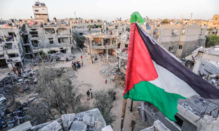 A Palestinian flag atop a destroyed building in Beit Hanoun, Gaza, 26 May 2021.