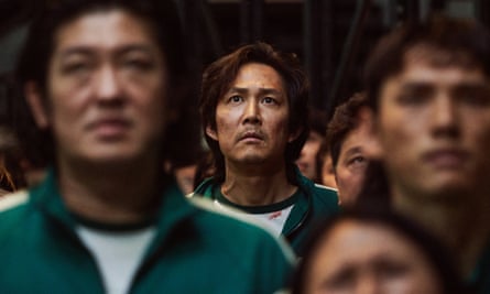 people in green jumpsuits looking worried