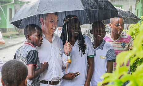 Colombian president Juan Manuel Santos poses with children before a religious ceremony with victims of violence in Bojayá, Colombia, 9 October 2016.