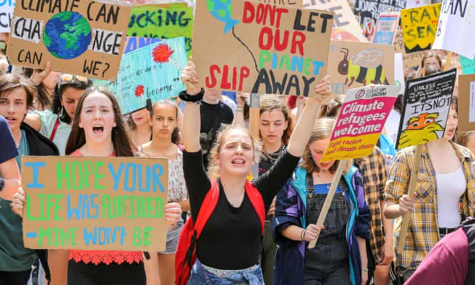 Students seen holding placards while chanting slogans during the Youth Strike for Climate Change