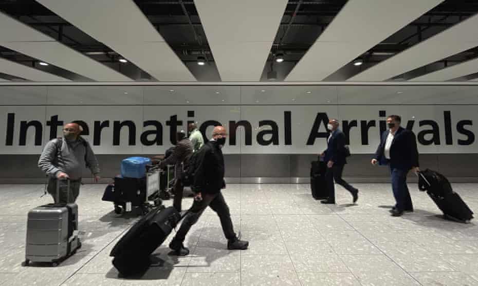 Passengers walk through the arrivals area of Heathrow’s Terminal 5 on Friday.