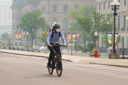 A cyclist wears a mask due to poor air quality in Ottawa on 6 June.