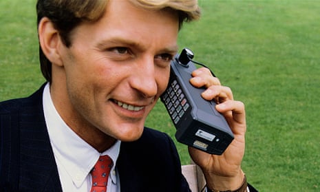 Man using a 1980s mobile phone