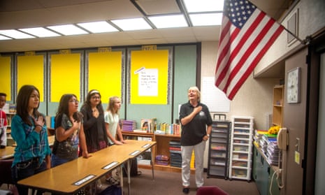 A teacher leads her middle school students in the Pledge of Allegiance on the first day of middle school in Aliso Video, California.