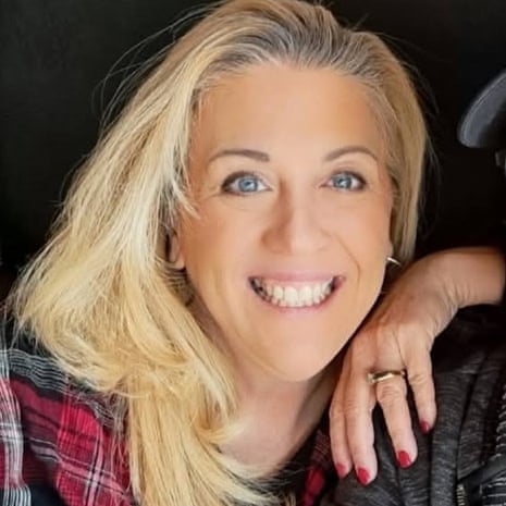 Becky Drury, a teacher wounded in a shooting, smiles resting her chin on her hand