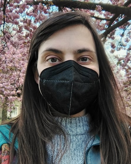 Jade standing under a cherry blossom tree