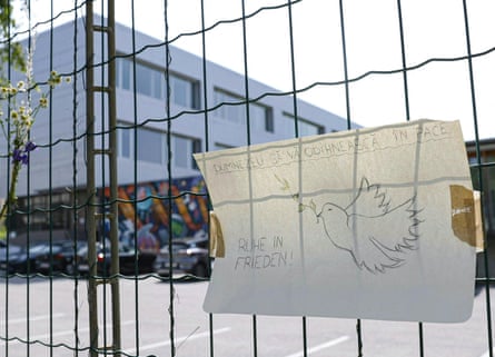 A condolence message hangs on school railings with dove and ‘ruhe in Frieden’