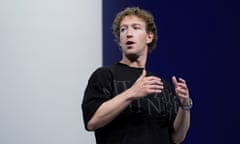 a man in a t-shirt speaks on stage