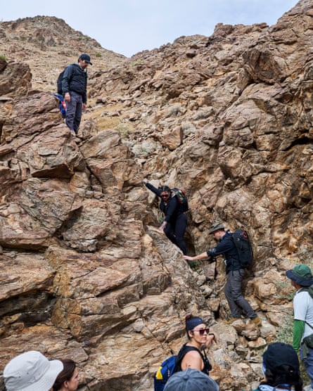 people descend a rocky wall