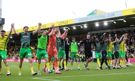 Norwich city players celebrate following their 1-0 victory over local rivals Ipswich Town.