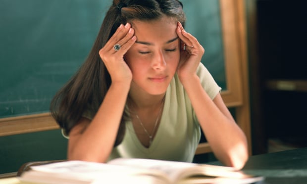 Young woman on desk looking stressed