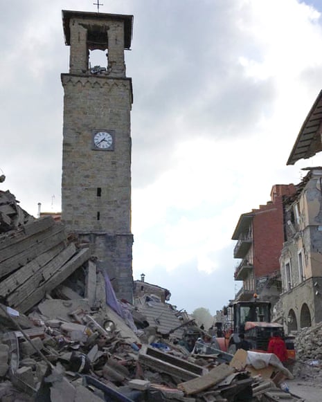 The partially damaged tower bell with the clock signing the time of the earthquake is seen in Amatrice