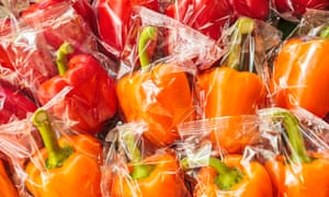Peppers wrapped individually in plastic.