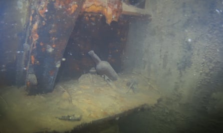 Bottles and other artifacts sit on a shelf in a cabin on the lower deck of HMS Terror.