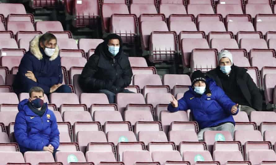 Lionel Messi (centre) watches on from the stands.