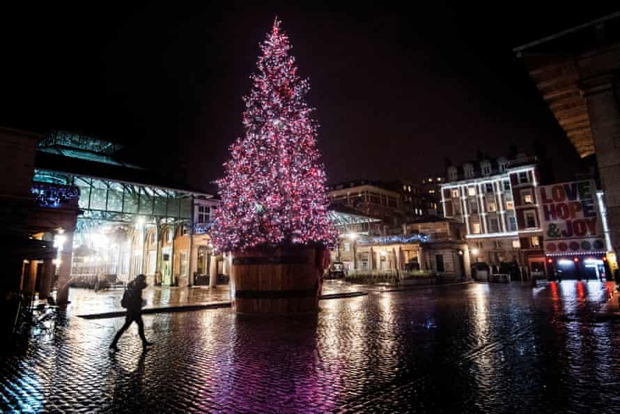 A Christmas tree lights up a quiet Covent Garden in central London.