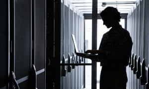 Person with laptop in data centre