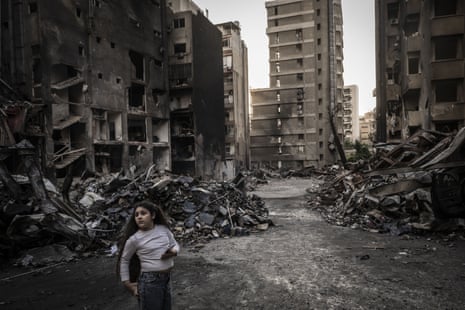 A girl in rubble caused by Israeli airstrikes targeting the Corniche al-Mazraa area in Beirut, Lebanon, on Friday.
