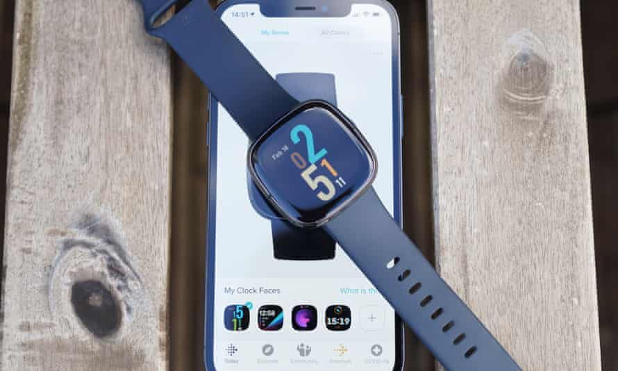 Fitbit Sense on top of smartphone