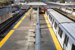 A lone commuter waits for a San Francisco-bound Bart train at an empty station south of San Francisco, California.