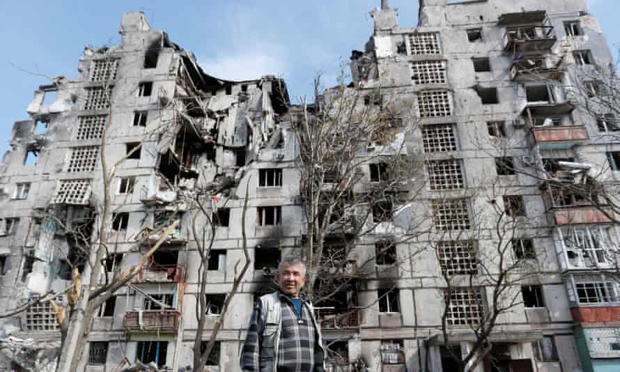 Local resident Sergei Shulgin, 62, stands in front of a block of flats heavily damaged in the southern port city of Mariupol, Ukraine.