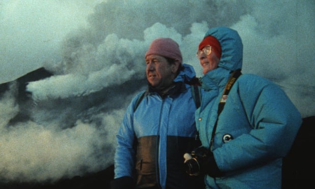 Katia and Maurice Krafft gaze upon a volcano in the distance