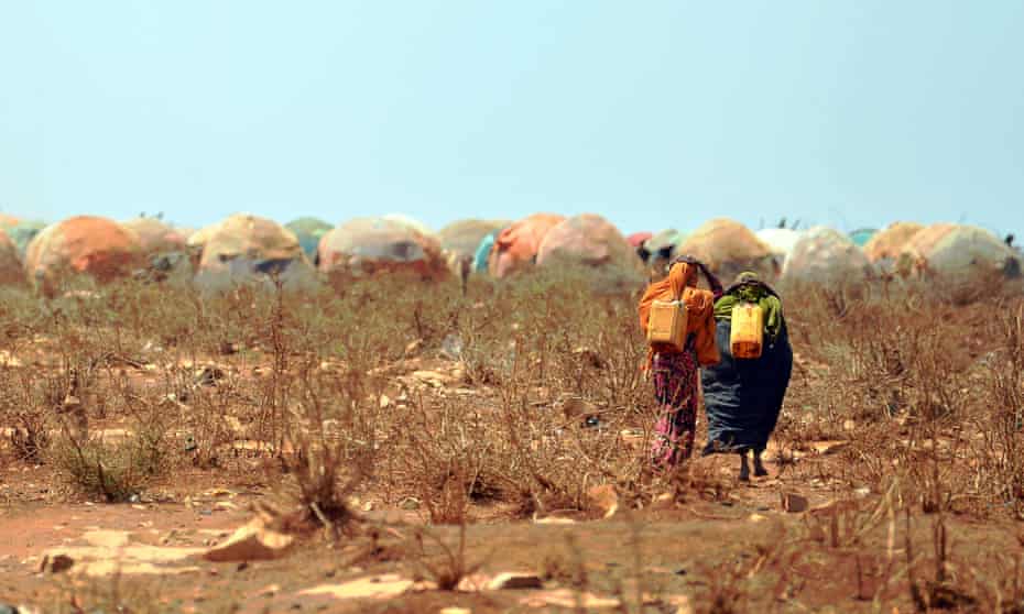 Women carrying jerrycans of water