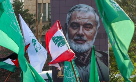 A portrait of slain Hamas leader Ismail Haniyeh among flags at a demonstration