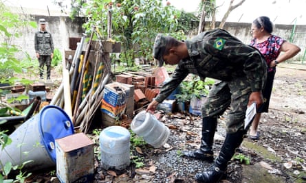 Armed forces members check a house for mosquito breeding areas in a rural area in Brazlândia, 45km northwest of Brasília.