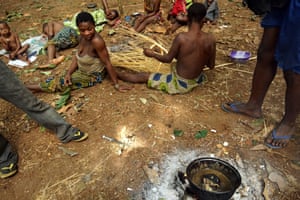 Poachers cook a monkey's head at the Ba'aka camp