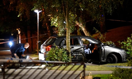 Police officers examine a car involved in a shooting incident in Malmö on Monday night. 