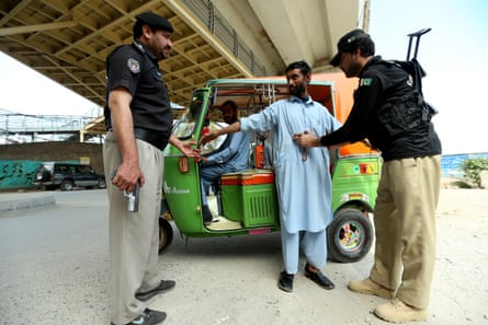 A Pakistani security official frisks a man at a checkpoint in Peshawar, capital of Khyber Pakhtunkhwa